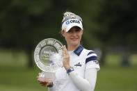 Nelly Korda holds the trophy after winning the Meijer LPA Classic golf tournament, Sunday, June 20, 2021, in Grand Rapids, Mich. (AP Photo/Al Goldis)