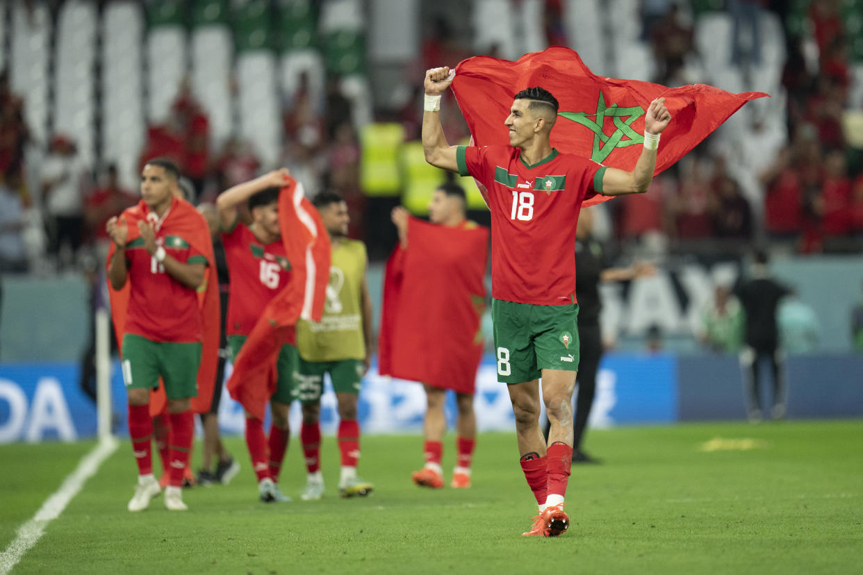 Morocco's Jawad El Yamiq reacts with teammates after the World Cup after Morocco beat Spain in a penalty kick shootout. (AP Photo/Julio Cortez)