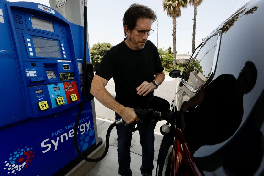 LOS ANGELES, CA MAY 18, 2022 - David Pippenger begins to put gas into his rental car at a Mobil gas station at 77th & Sepulveda in Westchester before flying home to Oregon on Wednesday, May 18, 2022. The average price of a gallon of self-serve regular gasoline in Los Angeles County rose to a record today, increasing to $6.089. The average price has risen for 21 consecutive days. (Al Seib / For The Times)