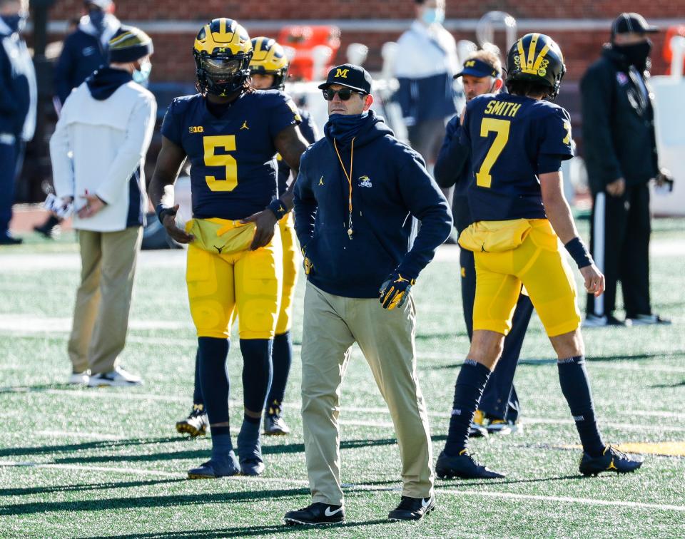 Michigan coach Jim Harbaugh watches warm up before the Penn State game at Michigan Stadium in Ann Arbor, Saturday, Nov. 28, 2020.