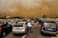 <p>Cars are blocked at the closed National Road during a wildfire in Kineta, near Athens, on July 23, 2018. (Photo: Valerie Gache/AFP/Getty Images) </p>