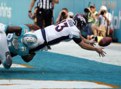 <p>Denver Broncos quarterback Trevor Siemian (13) fumbles the ball as he is tackled by Miami Dolphins defensive end Cameron Wake (91) for safety score, during the first half of an NFL football game, Sunday, Dec. 3, 2017, in Miami Gardens, Fla. (AP Photo/Wilfredo Lee) </p>