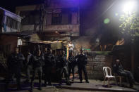 FILE - In this May 5, 2021 file photo, Israeli police stand guard in front of a Palestinian home occupied by settlers during a protest on the eve of a court verdict that may forcibly evict Palestinian families from their homes in the Sheikh Jarrah neighborhood of Jerusalem. The threatened evictions have sparked weeks of protests and clashes in recent days, adding to the tensions in Jerusalem. (AP Photo/Maya Alleruzzo, File)