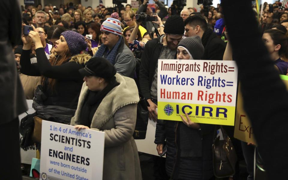 Demonstrators gather for a rally supporting immigrant rights, Saturday, Jan. 14, 2017 in Chicago. Immigrant rights advocates are planning demonstrations across the country in what they're calling a "first salvo" against President-elect Donald Trump's pledged hard line on immigration. (Abel Uribe/Chicago Tribune via AP)