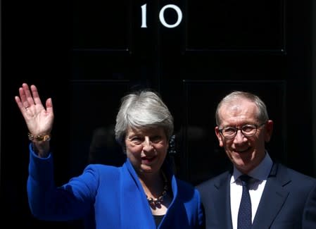 Theresa May waves next to her husband Philip outside Downing Street, on her last day in office as Britain's Prime Minister, in London