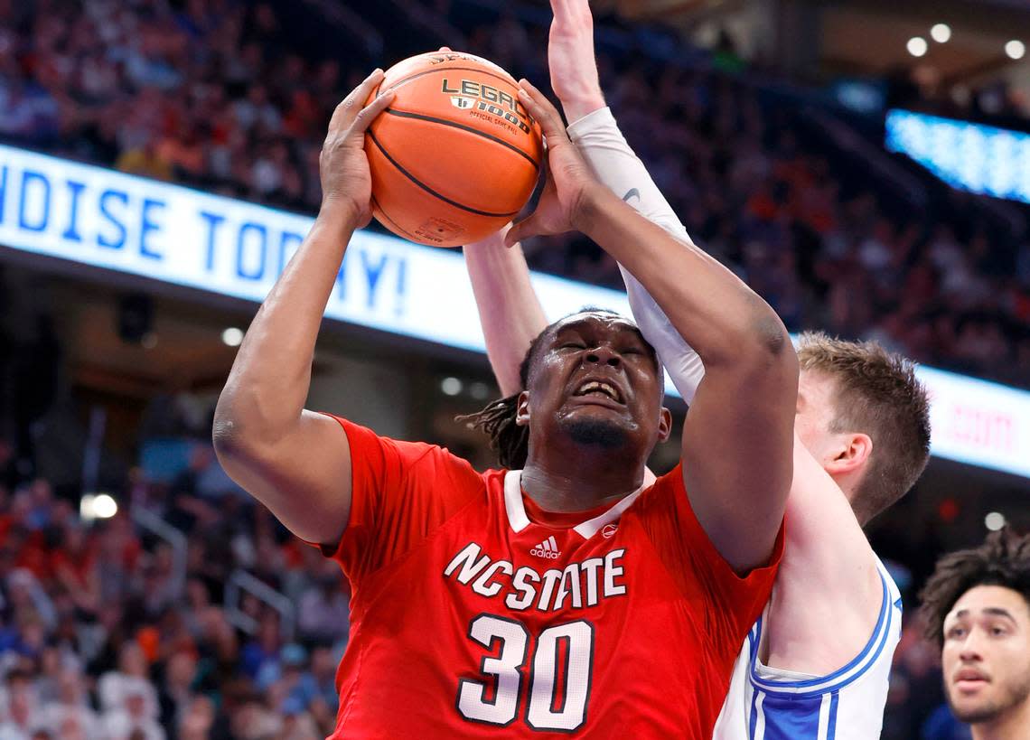 N.C. State’s DJ Burns Jr. (30) heads to the basket as Duke’s Kyle Filipowski (30) defends during the second half of N.C. State’s 74-69 victory over Duke in the quarterfinal round of the 2024 ACC Men’s Basketball Tournament at Capital One Arena in Washington, D.C., Thursday, March 14, 2024.