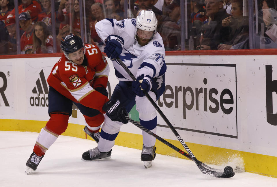Tampa Bay Lightning defenseman Victor Hedman (77) and Florida Panthers center Noel Acciari (55) battle for the puck during the second period of Game 1 of an NHL hockey second-round playoff series Tuesday, May 17, 2022, in Sunrise, Fla. (AP Photo/Reinhold Matay)