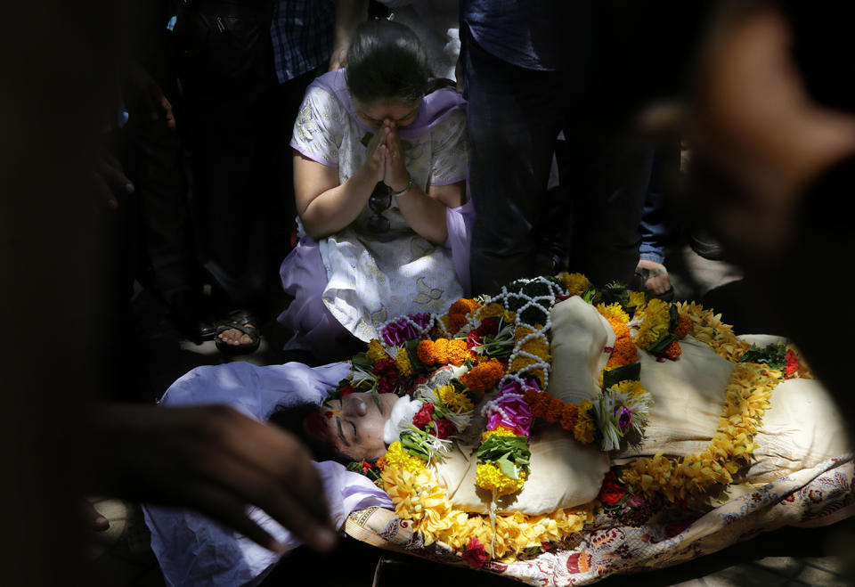 A woman wails near the body of Bollywood actress Reema Lagoo