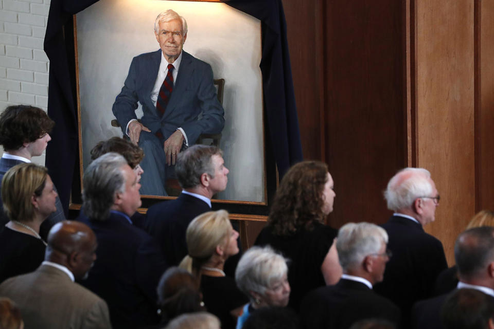 A portrait of the late Republican senator Thad Cochran, looms over family members, during funeral services at Northminster Baptist Church in Jackson, Miss., Tuesday, June 4, 2019. Cochran was 81 when he died Thursday in a veterans' nursing home in Oxford, Mississippi. He was the 10th longest serving senator.