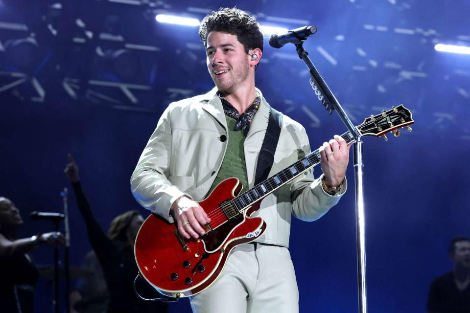 <p>Kevin Mazur/Getty</p> Nick Jonas performs onstage with Jonas Brothers in New York City in August 2023