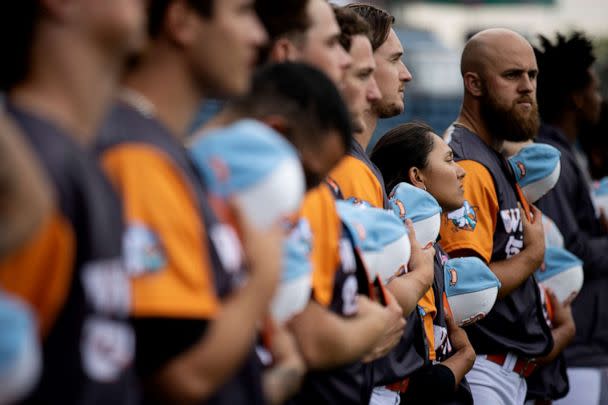 PHOTO: Kelsie Whitmore stands with her teammates for the National Anthem before their game against the Charleston Dirty Birds at Richmond County Bank Ballpark, July 8, 2022, in Staten Island, N.Y. (Al Bello/Getty Images)