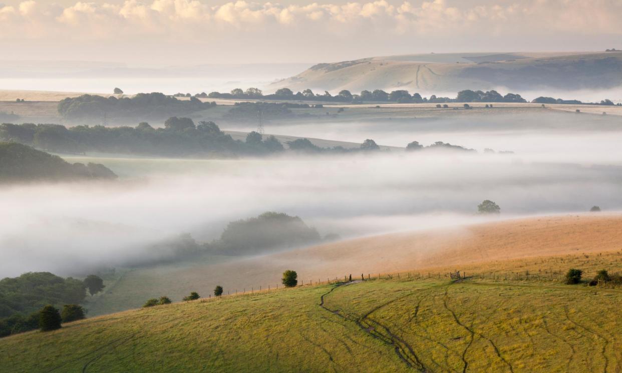 <span>Early morning mist hanging over the South Downs near Ditchling Beacon.</span><span>Photograph: James Barrett/Alamy</span>
