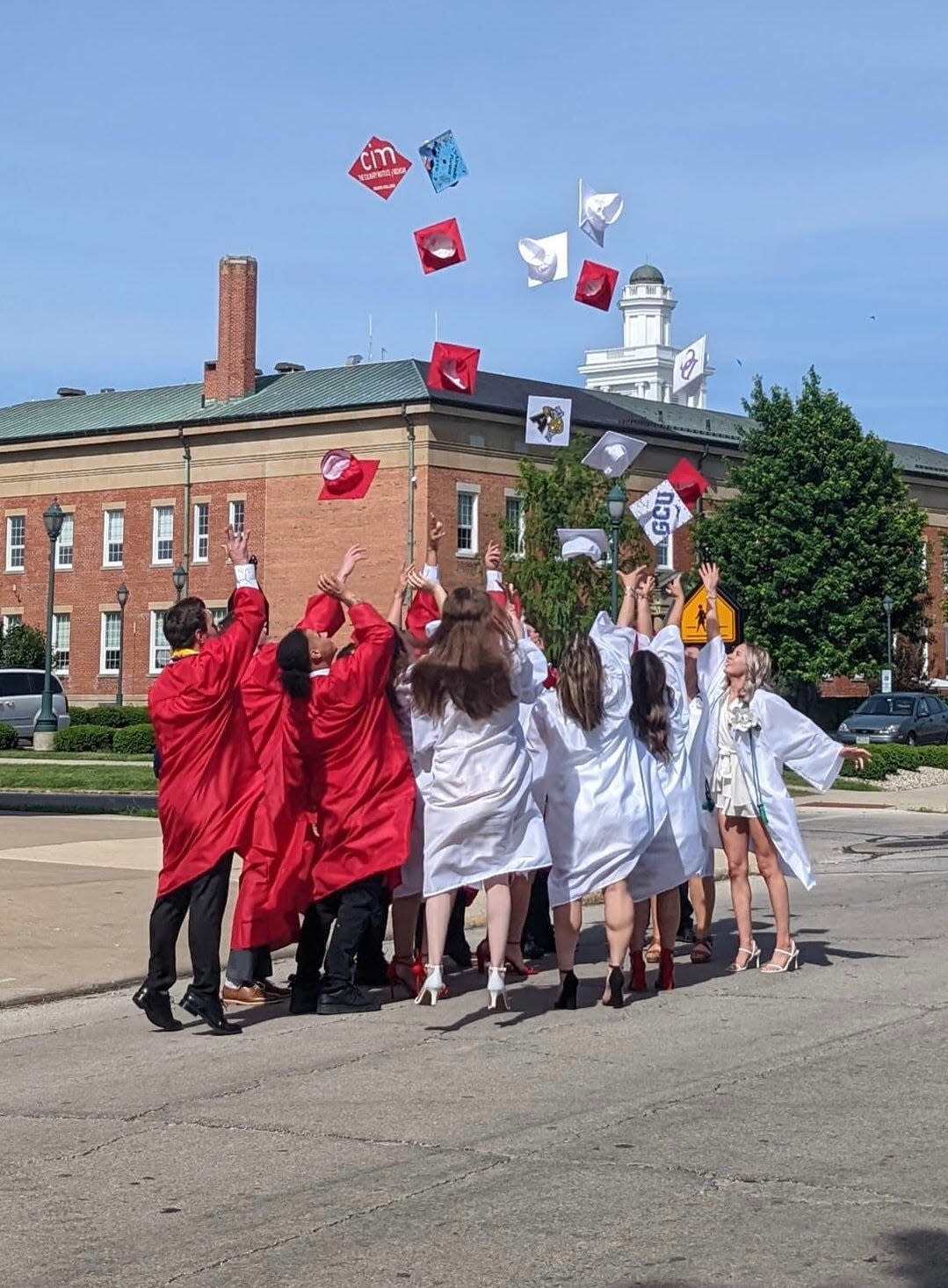 St. Joseph Central Catholic High School graduates toss their caps after their 2022 ceremony.