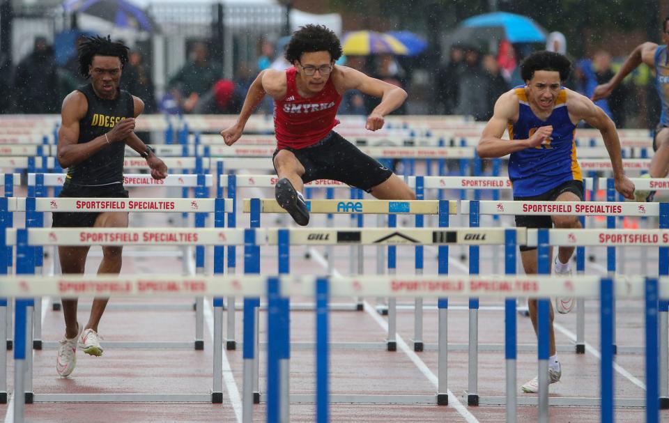 Smyrna's Elijah Williams (center) wins the Division I 110 meter hurdles ahead of second place Michael Latham of Odessa (left) and Gabe Harris of Caesar Rodney (right, third place) during the second day of the DIAA state high school track and field championships at Dover High School, Saturday, May 18, 2024.