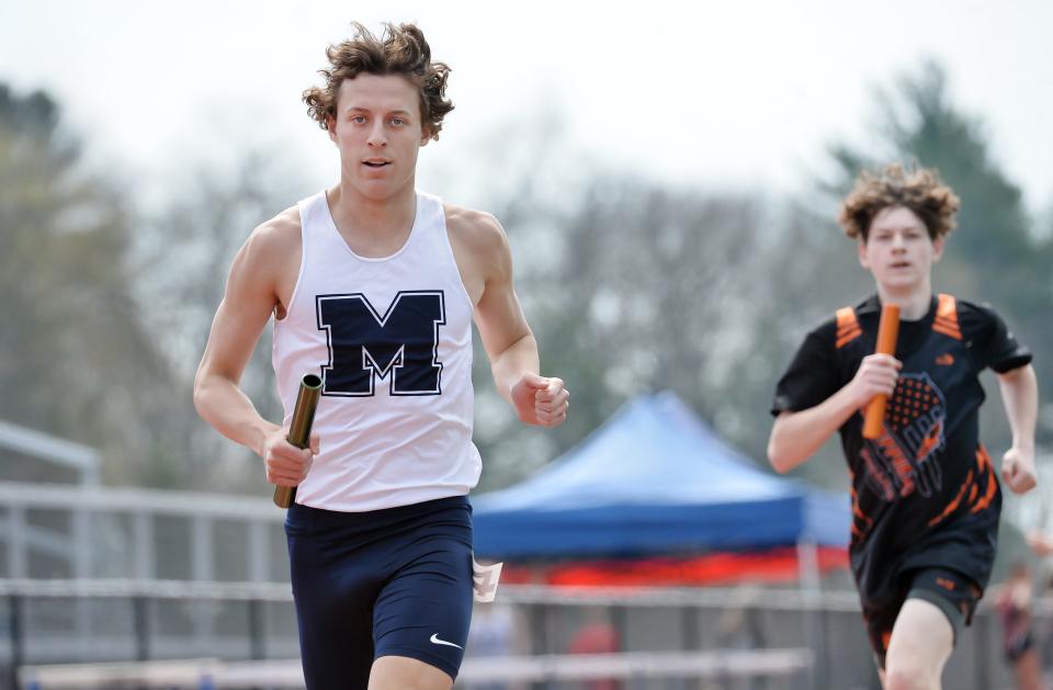 McDowell High School's Nicolin Pierce, left, competes in the boys 3,200-meter relay during Saturday's Fort LeBoeuf Invitational.