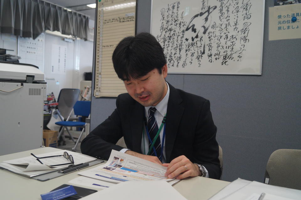 <p>Ryusuke Wakahoi, the deputy director of the Strategic Intelligence Analysis Office, reads through information on North Korea at the Ministry of Defense headquarters in Shinjuku, Tokyo. (Photo: Michael Walsh/Yahoo News) </p>