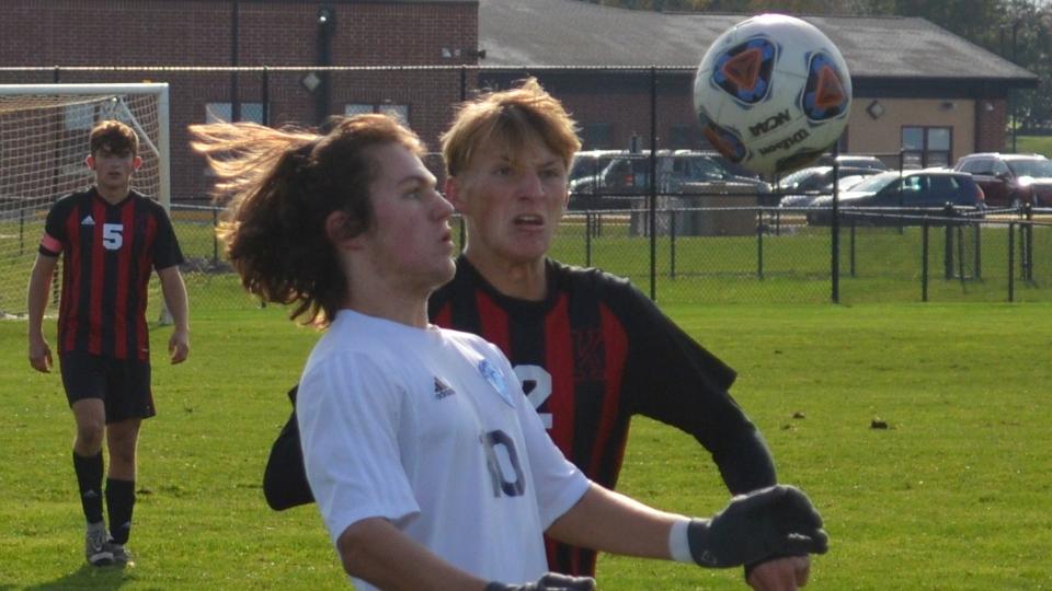 Matt McFadden of Shawnee (10) and Zach Webb of Kingsway follow the flight of a high bouncing ball during their South Jersey Group 4 quarterfinal on Thursday, November 4, 2021.