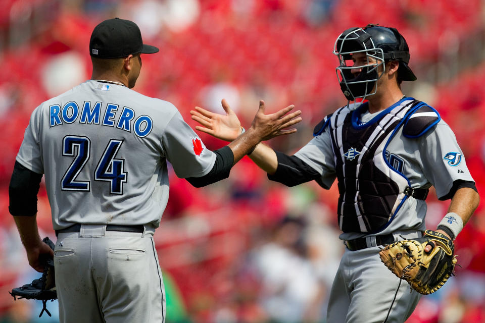 ST. LOUIS, MO - JUNE 26: Starter Ricky Romero #24 and J.P. Arencibia #9 both of the Toronto Blue Jays celebrate a victory against the St. Louis Cardinals at Busch Stadium on June 26, 2011 in St. Louis, Missouri.  (Photo by Dilip Vishwanat/Getty Images)