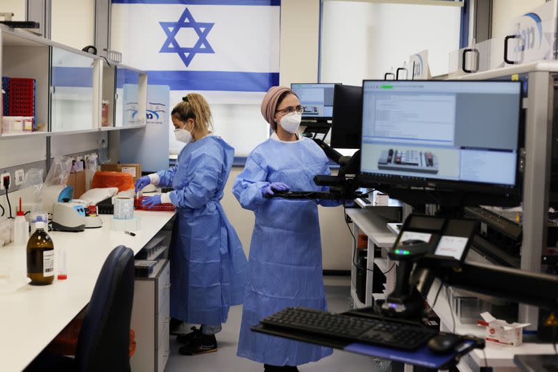 FILE PHOTO: Technicians work at Healthcare Maintenance Organization (HMO) Maccabi's coronavirus disease (COVID-19) public laboratory, performing diverse and numerous tests, in Rehovot