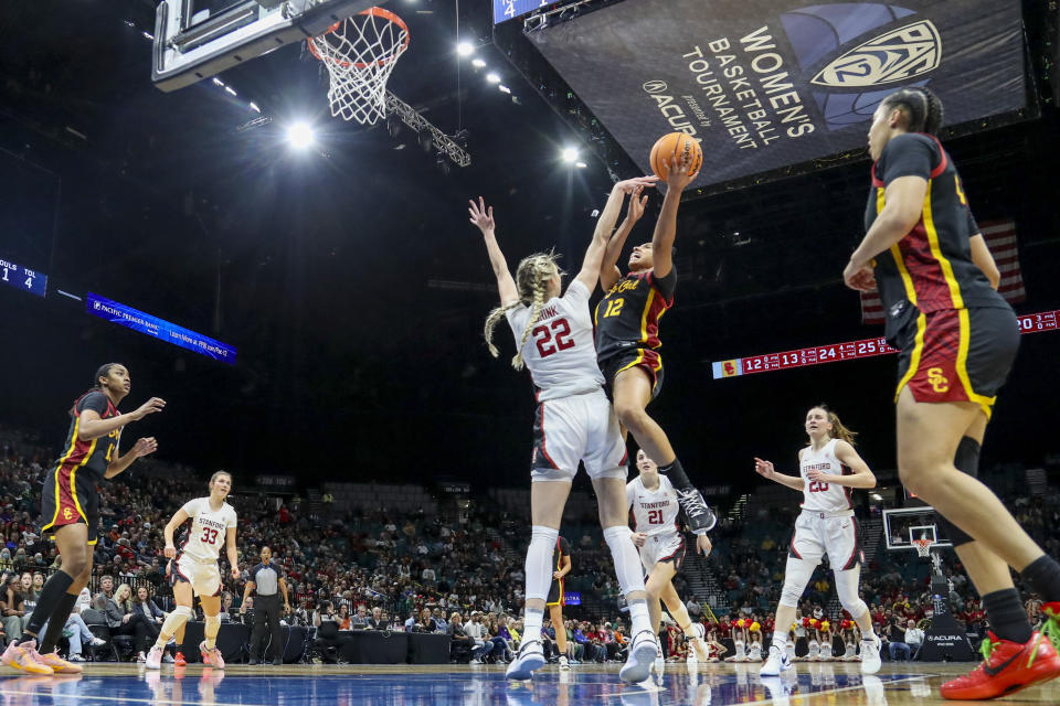 Southern California guard JuJu Watkins (12) shoots over Stanford forward Cameron Brink (22) during the first half of an NCAA college basketball game in the championship of the Pac-12 tournament Sunday, March 10, 2024, in Las Vegas. (AP Photo/Ian Maule)