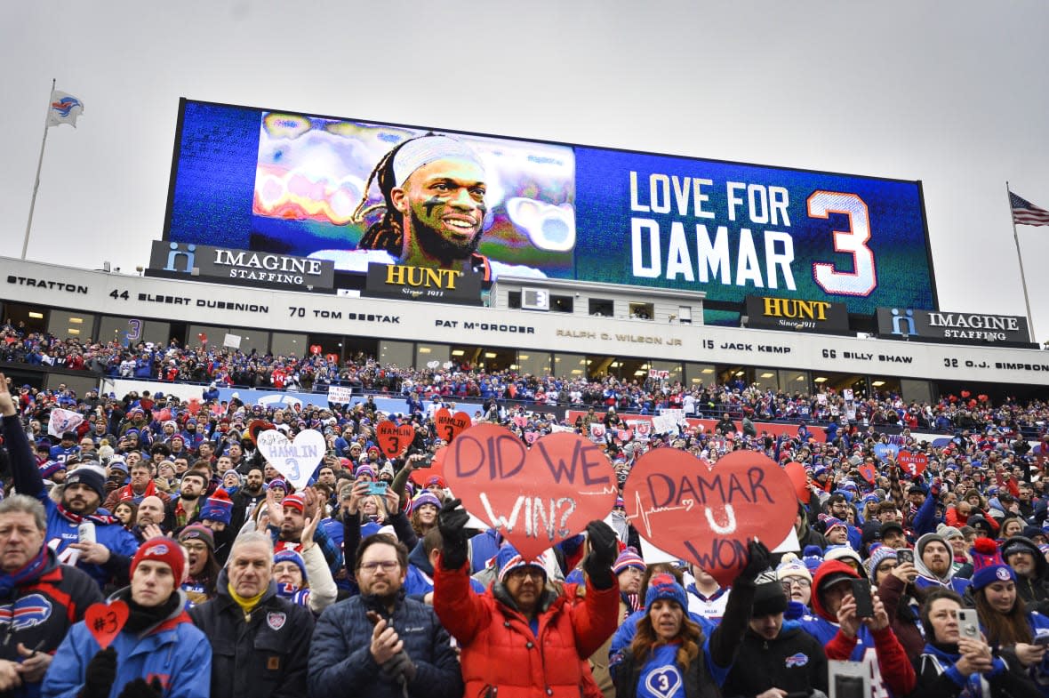 FFans stand in support for Buffalo Bills safety Damar Hamlin (3) before an NFL football game against the New England Patriots, Sunday, Jan. 8, 2023, in Orchard Park, N.Y. (AP Photo/Adrian Kraus, File)