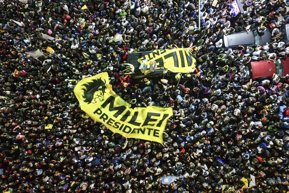Supporters of presidential candidate Javier Milei gather outside his campaign headquarter after Economy Minister Sergio Massa, candidate of the Peronist party, conceded defeat in the presidential runoff election in Buenos Aires, Argentina, Sunday, Nov. 19, 2023. (AP Photo/Matias Delacroix)