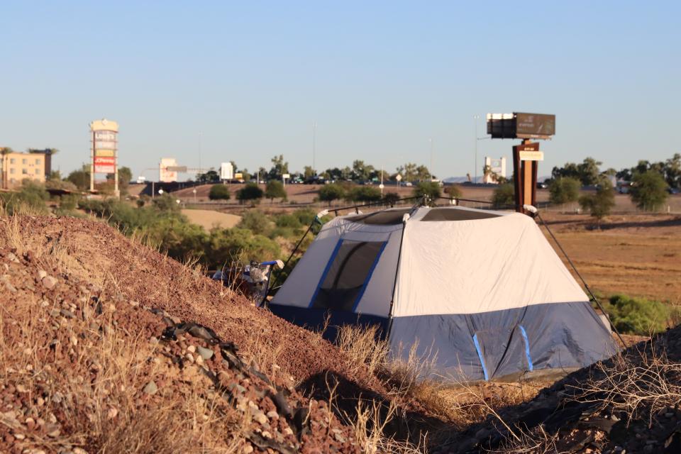 A tent sits outside a city-owned retention basin in Goodyear on Oct. 15, 2021. Now that officers can’t cite them as easily for camping, people experiencing homelessness are often cited for trespassing in Arizona  — an approach some critics see as a way for officers to circumvent court rulings prohibiting the criminalization of homelessness. (Photo by Taylor Stevens) 