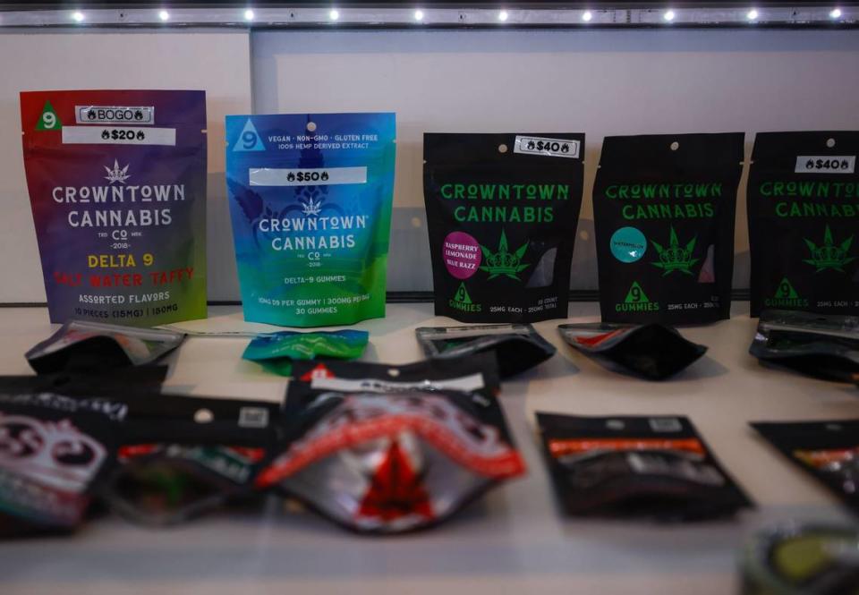 Delta-9 gummies line the inside of a display case inside Crowntown Cannabis on North Davidson Street on Tuesday, April 9, 2024.