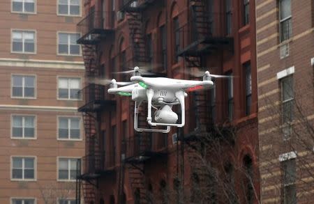 A camera drone flown by Brian Wilson flies near the scene where two buildings were destroyed in an explosion, in the East Harlem section in New York City, March 12, 2014. REUTERS/Mike Segar