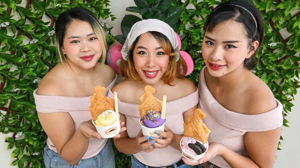 Cerena Lee, from left, her sisters Diamond Lee-Sok, and Sierra Lee hold samples of their taiyaki with ice cream and toppings at their Nummy Yummy shop in north Fresno on Wednesday, July 3, 3024.