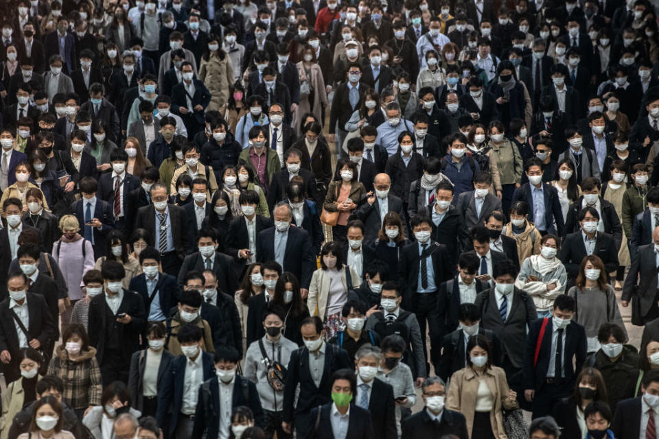 Commuters, mostly wearing face masks, walk through Shinagawa train station on November 18, 2020 in Tokyo, Japan.<span class="copyright">Carl Court/Getty Images</span>