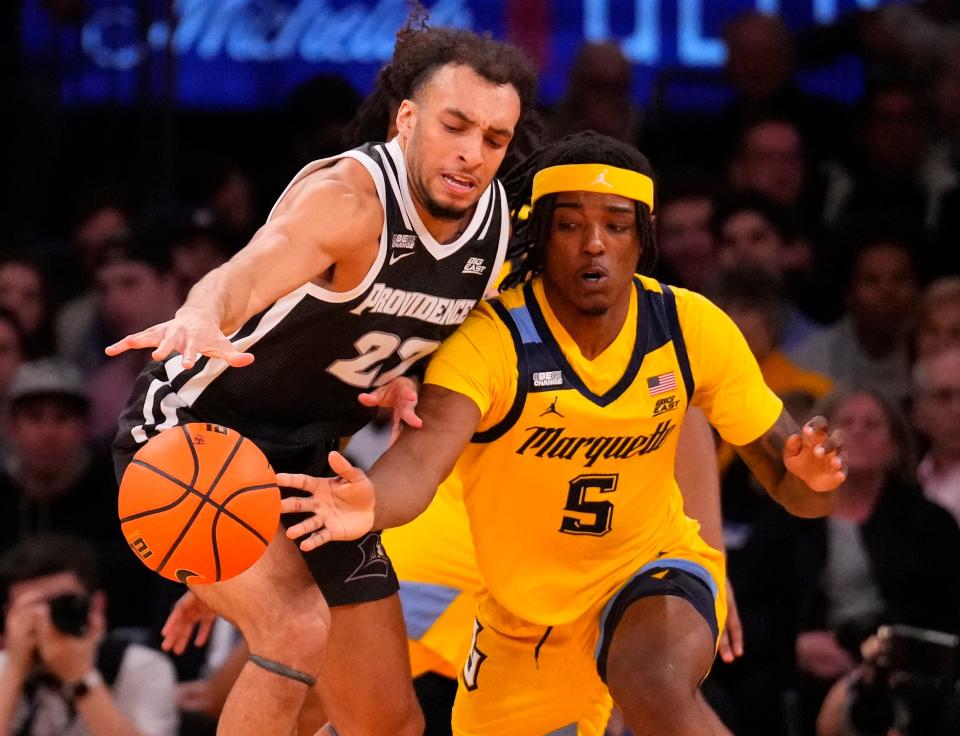 Providence Friars guard Devin Carter (22) and Marquette Golden Eagles guard Tre Norman (5) fight for a loose ball during the first half at Madison Square Garden on Friday night.