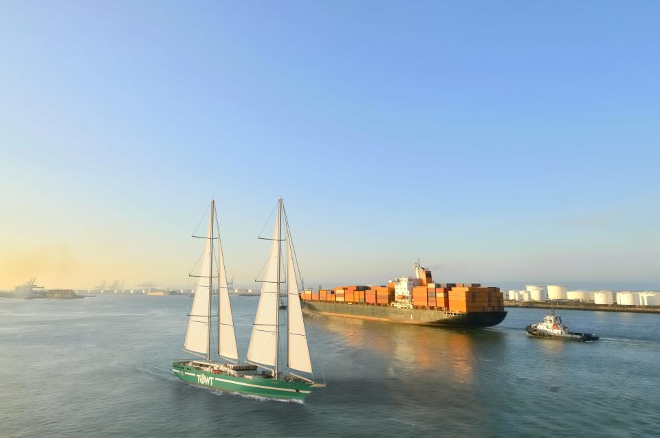 TransOceanic Wind Transport cargo sailboat next to cargo ship