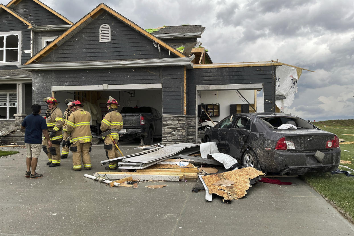 Firefighters work to clear a home damaged in Nebraska