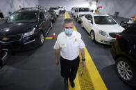 Sterling Heights Fire Department Chief Kevin Edmond works at a vaccine distribution location in Sterling Heights, Mich., Wednesday, April 28, 2021. Edmond, who’s been a firefighter and EMT for 35 years, said younger staffers are more open to the department’s mental health and peer support programs. “When I first started, there wasn’t such a thing. … It was basically you’ll get over it,” he said. “Unfortunately, because of our profession, we see a lot of bad things.” (AP Photo/Paul Sancya)