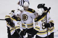 Boston Bruins, clockwise from foreground left, Torey Krug (47), Patrice Bergeron, Justin Florek, Reilly Smith and Kevan Miller (86) celebrate Krug's goal during the second period of Game 4 of a first-round NHL hockey playoff series against the Detroit Red Wings in Detroit, Thursday, April 24, 2014. (AP Photo/Carlos Osorio)