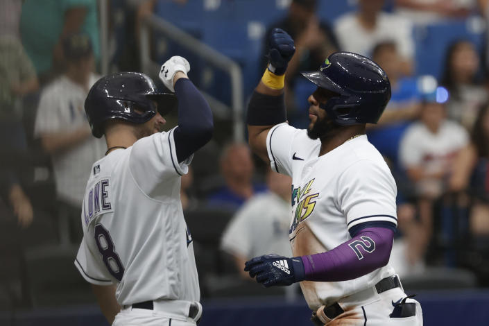 Tampa Bay Rays' Yandy Diaz, right, celebrates with teammate Brandon Lowe after hitting a home run against the Cleveland Guardians during the fifth inning of a baseball game Saturday, July 30, 2022, in St. Petersburg, Fla. (AP Photo/Scott Audette)