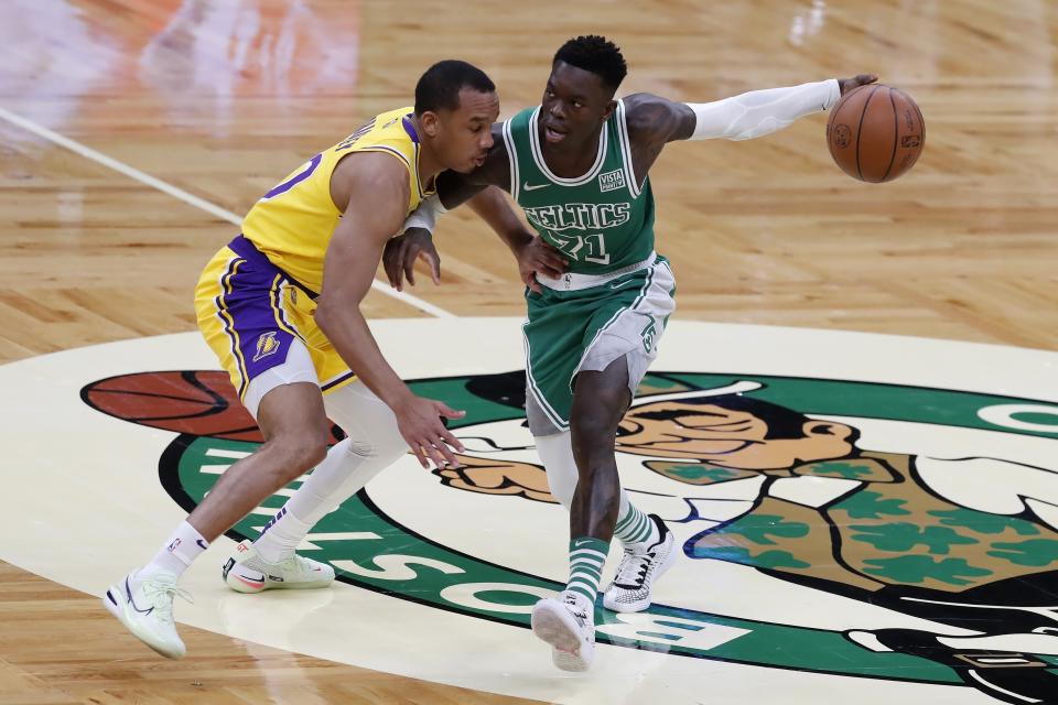 Boston Celtics' Dennis Schroder (71) keeps the ball away from Los Angeles Lakers' Avery Bradley during the first half of an NBA basketball game, Friday, Nov. 19, 2021, in Boston. (AP Photo/Michael Dwyer)