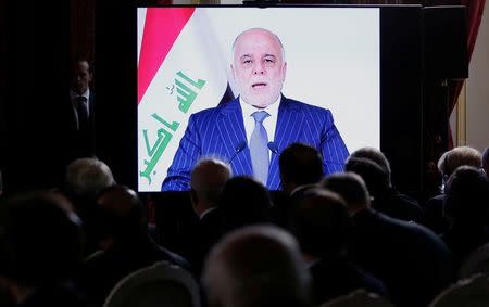 Iraqi Prime Minister Haider al-Abadi is seen on a screen as he speaks via a videoconference during a ministerial summit to hold discussion on the future of Mosul city, post-Islamic State, in Paris, France, October 20, 2016. REUTERS/Regis Duvignau