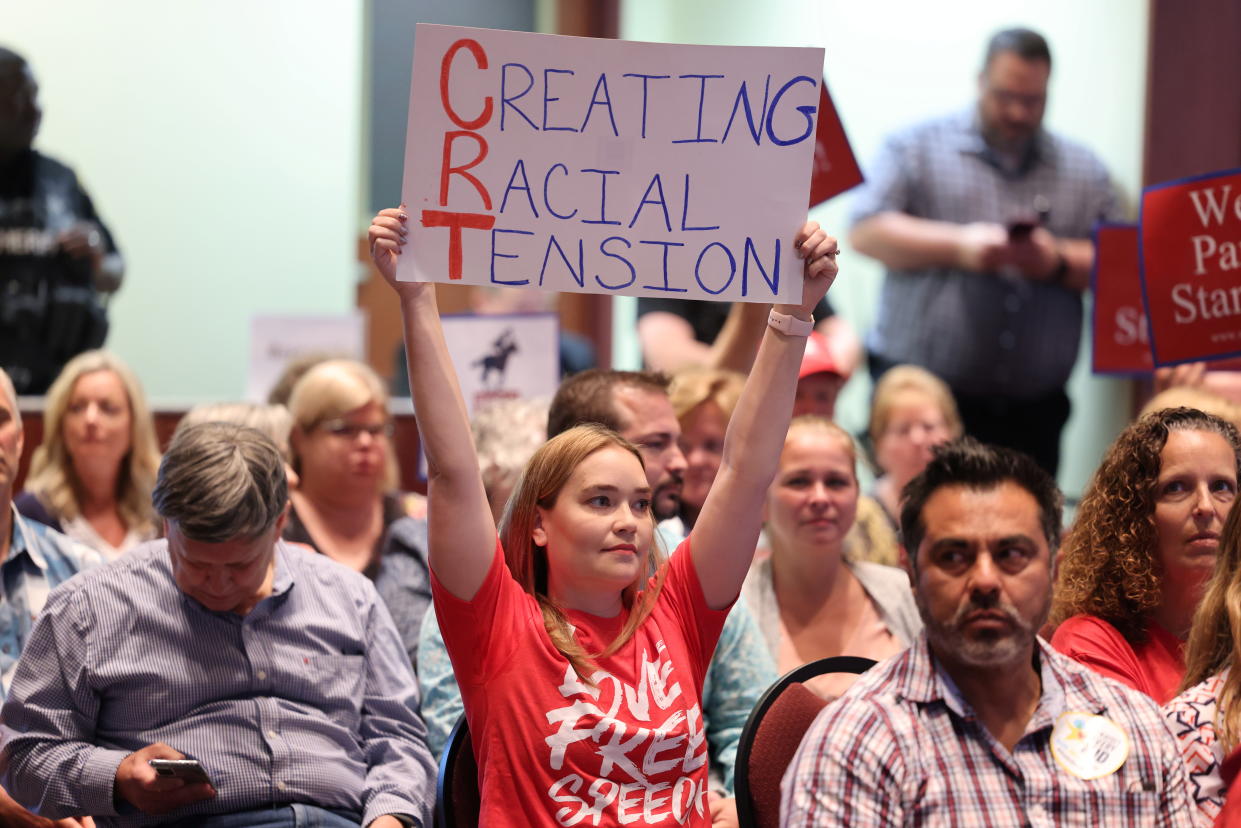 A protester holding a sign saying 