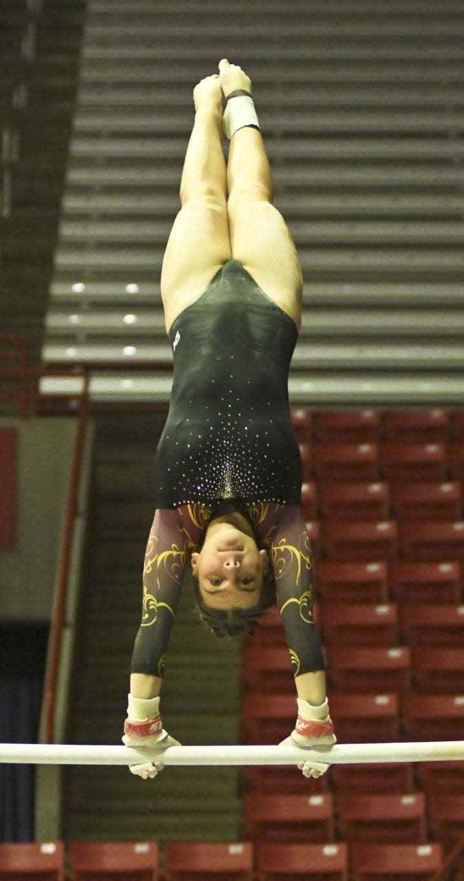 Bloomington North's Hannah Abel competes on bars during the IHSAA state gymnastics meet at Ball State on Saturday, March 11, 2023.