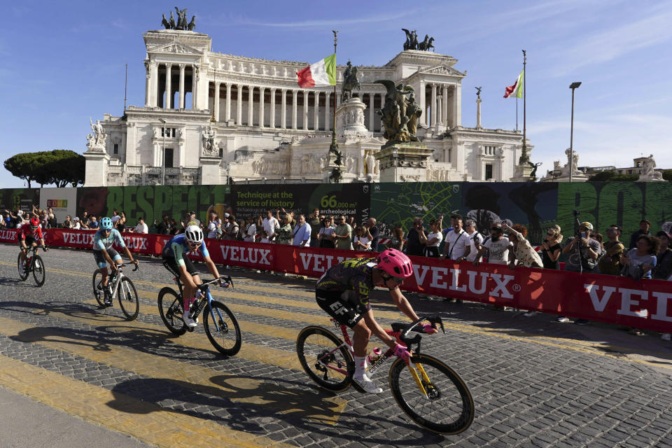 Cyclists ride past the Unknown Soldier monument during the final stage of the Giro d'Italia cycling race, in Rome, Sunday, May 26, 2024. (Fabio Ferrari/LaPresse via AP)