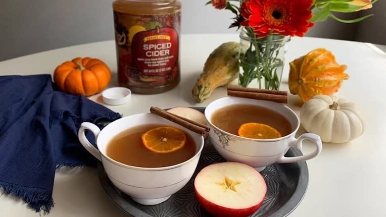 Two cups of spiced cider on tray