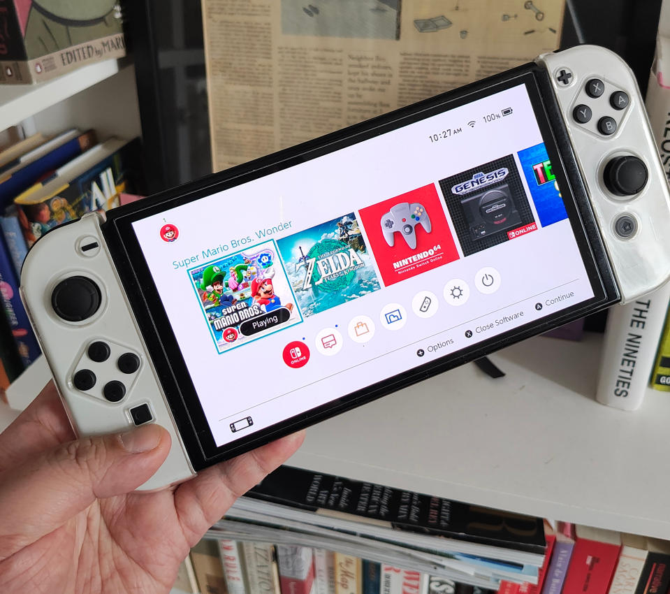 Lifestyle photo of Nintendo Switch OLED in white with plastic case