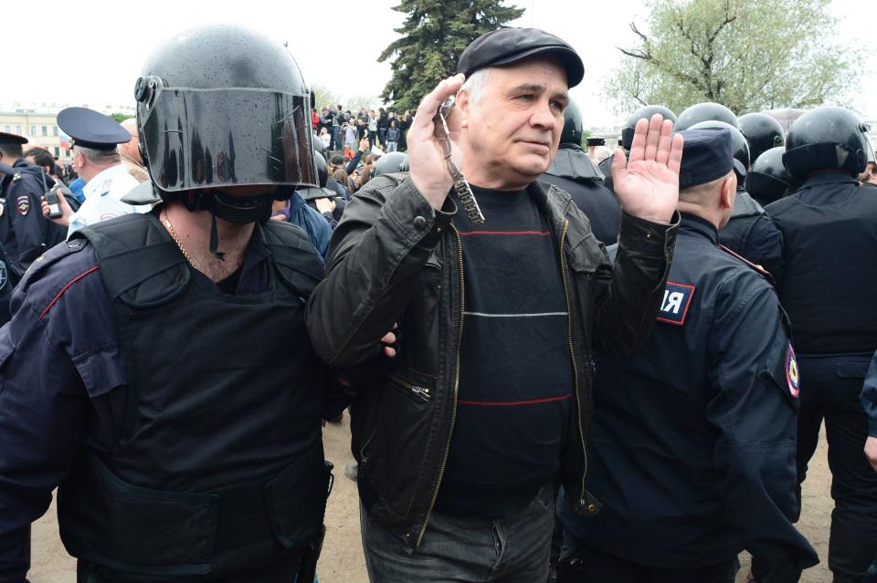 Russian police officers detain a participant.&nbsp;