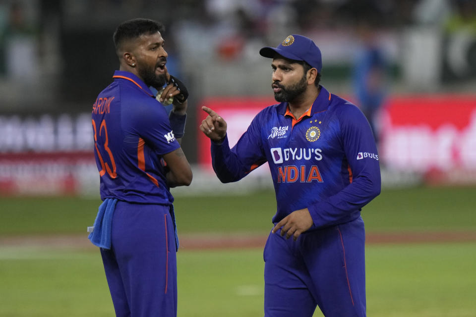 India's Hardik Pandya, left, listens to captain Rohit Sharma before bowling his next delivery during the T20 cricket match of Asia Cup between India and Pakistan, in Dubai, United Arab Emirates, Sunday, Sept. 4, 2022. (AP Photo/Anjum Naveed)