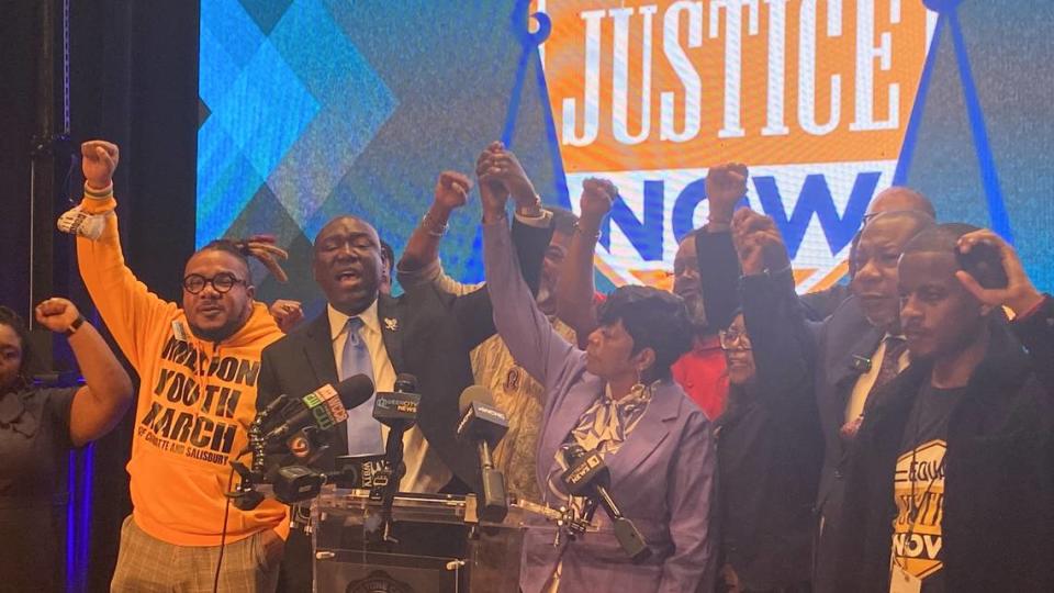 Attorney Benjamin Crump raises the hand of Sallamondra Robinson and calls for justice for her daughter, Shanquella Robinson at a news conference at Livingstone College on March 23, 2023 Kallie Cox/kcox@charlotteobserver.com