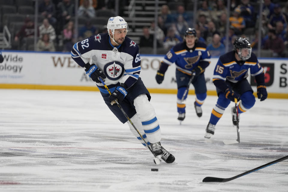 Winnipeg Jets' Nino Niederreiter brings the puck down the ice during the first period of an NHL hockey game against the St. Louis Blues Sunday, March 19, 2023, in St. Louis. (AP Photo/Jeff Roberson)