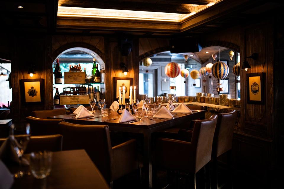 a large dining room with a large mirror above it