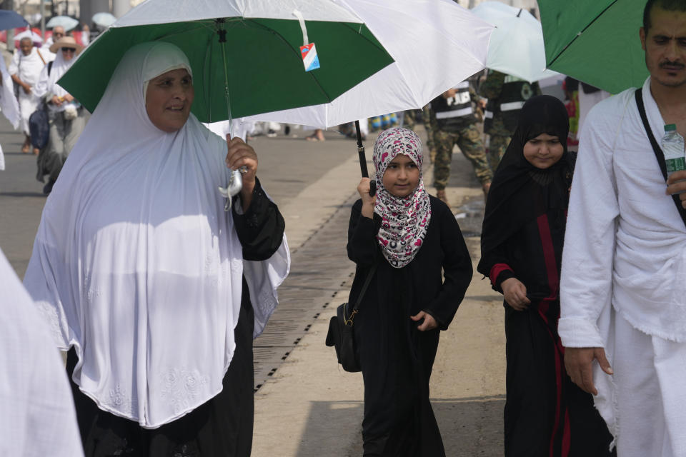 Muslim pilgrims arrive at the Mina tent camp during the annual Hajj pilgrimage, near the holy city of Mecca, Saudi Arabia, Friday, June 14, 2024. Hajj is the annual Islamic pilgrimage to Mecca in Saudi Arabia that is required once in a lifetime of every Muslim who can afford it and is physically able to make it. Some Muslims make the journey more than once. (AP Photo/Rafiq Maqbool)